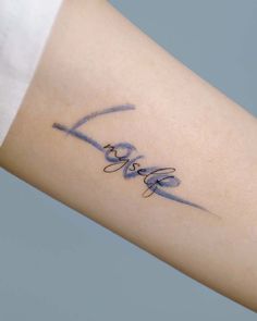 the word love is written in cursive writing on a woman's arm