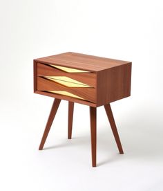 a small wooden table with two drawers on one side and an open drawer on the other