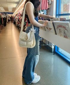 a woman looking at clothes in a store