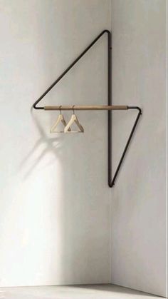 two clothes hangers are hanging on the wall