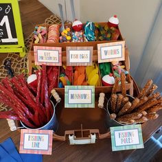 an assortment of candy and candies displayed on a table with place cards for each individual