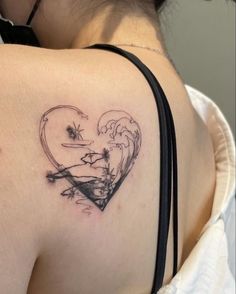 a woman with a heart tattoo on her shoulder