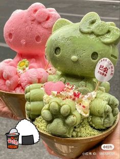 two hello kitty ice creams in bowls with green and pink frosting on them