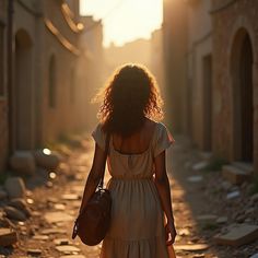 a woman in a dress walking down a street with her back turned to the camera