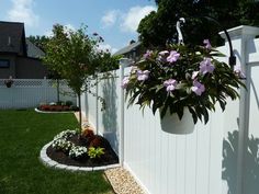 a white fence with flowers growing in it