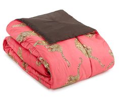 a pink comforter with gold and brown designs on it, folded up in front of a white background