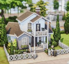 a blue house with white picket fence and trees