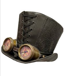 This is a black embossed  Steampunk leatherette top hat by SDL.  This remarkable green top hat by SDL is a must-have for any steampunk enthusiast. The metal embossed design adds a touch of elegance and the unisex size of 60cm ensures a comfortable fit.  The hat is perfect for any occasion and complements any outfit. The goggles add a unique touch to the design, making it stand out from the rest. The hat is perfect for those who love to accessorise and make a statement. It has cog embossed detail Steampunk Hat With Goggles, Black Leather Steampunk Top Hat, Steampunk High Crown Top Hat For Cosplay, Adjustable Steampunk Top Hat For Themed Events, Black Steampunk Costume Accessories For Themed Events, Gothic Black Top Hat For Themed Events, Vintage Fitted Top Hat For Cosplay, Black Gothic Top Hat For Themed Events, Black Steampunk Hat For Cosplay