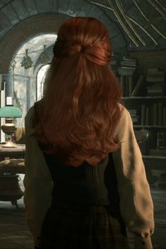 a woman with long red hair standing in a room