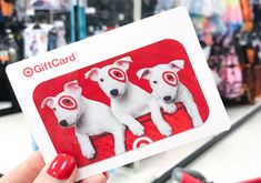 a person holding up a card with two dogs on it