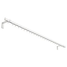 a white shelf with three hooks on it