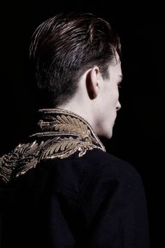 the back of a man's head with an elaborate collar