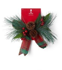 a christmas decoration with pine cones and holly