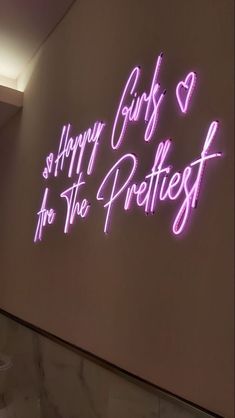 a neon sign that says happy girls and she's the prettiest in pink