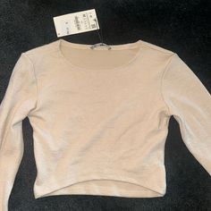 Long Sleeve Zara Top. Ribbed. Very Stretchy. Slightly Cropped. Very Soft Material. Tags Still On Never Worn Spring Beige Tops With Ribbed Neckline, Zara Ribbed Tops For Spring, Zara Basic Stretch Crop Top, Casual Ribbed Crop Top By Zara, Beige Stretch Tops With Ribbed Neckline, Zara Stretch Knit Top With Long Sleeves, Zara Casual Ribbed Crop Top, Fitted Beige Top With Ribbed Neckline, Zara Ribbed Crew Neck Top