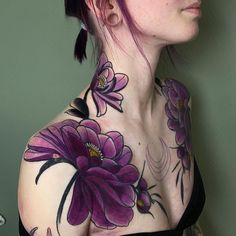 a woman with purple flowers on her chest