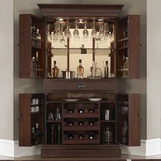 a wooden cabinet with wine glasses and bottles in it