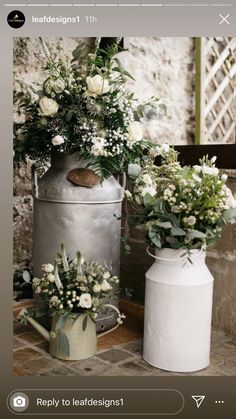 two vases filled with flowers sitting on top of a table next to each other