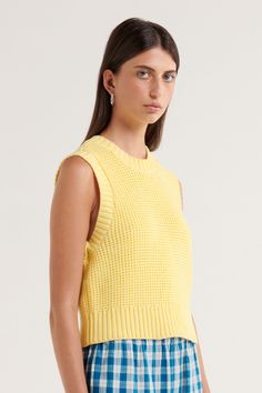 Our Sunday by s t e e l e . collection is a carefully curated range of effortless and easy to wear pieces designed for slow days and everyday use. The Carolina Knit Top is the fun splash of colour missing from your wardrobe! This boxy knit top is slightly cropped and featured ribbed edge detailing at the armholes, neck and hem, and the lush, buttery yellow is the perfect shade to carry through the seasons. Wear with all three ties together or for a more boxy look, wear with one or two ties left undone. Cropped boxy knit 100% cotton knit fabric Ribbed edge details Pull over entry into garment Three tie details at back This style is unlined Sophie is 178cm and wears a size small. Slow Days, Yellow Skirt, Butter Yellow, Knitted Vest, Knit Tie, Vest White, Knit Vest, Summer Cotton, Cotton Knit