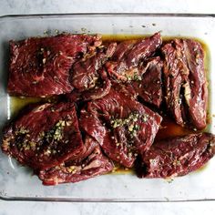 raw meat is sitting in a glass dish