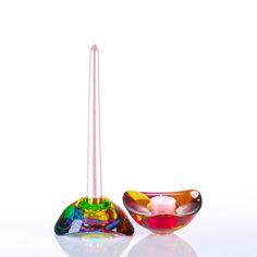 two colorful glass bowls sitting next to each other