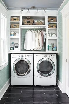 a washer and dryer in a laundry room with shelves on the wall above them