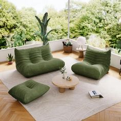 a living room filled with green furniture and lots of trees in the backround