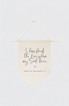 a white banner hanging on a wall with the words, i have found the one whom my soul loves