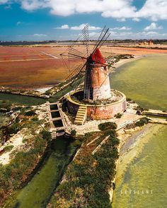 an aerial view of a windmill in the water