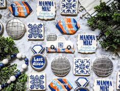 many decorated cookies are on a table with blue and white decorations, including one for the chicago cubs