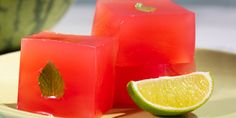 two cubes of watermelon and one slice of lime on a plate