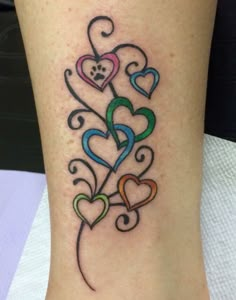 a woman's stomach with the word love and hearts tattooed on her back shoulder