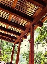 the inside of a wooden structure with benches and trees in the backgrouds