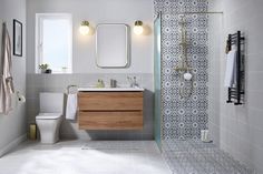 a bathroom with a sink, toilet and shower