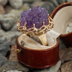 This awesome ring features an amethyst point geode cluster that is prong set in a lovely open gold work border. It is crafted in 14k yellow gold and is currently a size 8.75. Unique Gold Amethyst Ring, Formal Gold Amethyst Crystal Ring, Unique Gold Amethyst Ring For Wedding, Elegant Raw Stone Wedding Rings, Gold Amethyst Ring With Large Stone As Gift, Elegant Wedding Rings With Raw Stone, Elegant Ring With Raw Stone, Luxury Multi-stone Yellow Gold Amethyst Ring, Yellow Gold Amethyst Cabochon Ring