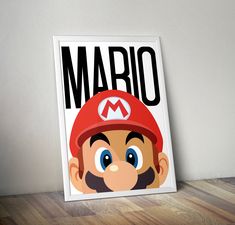 a mario bros poster is on the wall next to a wooden table with a lamp