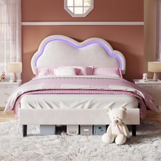 a bedroom with a bed, dresser and teddy bear on the floor in front of it