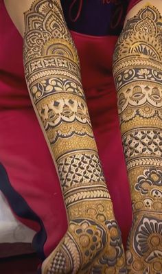 the legs and arms of a woman with henna tattoos