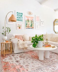 a living room filled with lots of furniture and pictures on the wall above it's coffee table