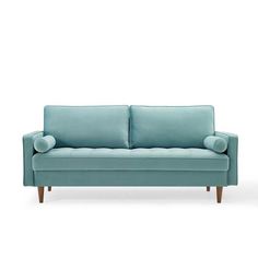 a blue couch sitting on top of a white floor