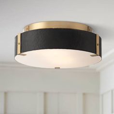 a black and gold ceiling light in a room