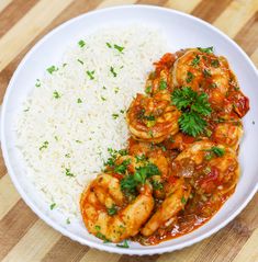 a white plate topped with shrimp and rice