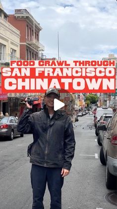 a man standing in the middle of a street holding up a sign that says food crawl through san francisco chinatown