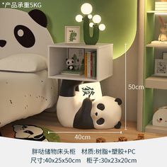 a panda bear lamp sitting on top of a bed next to a book shelf with books