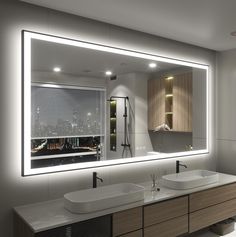 a bathroom with two sinks and a large mirror in it's wall above the sink