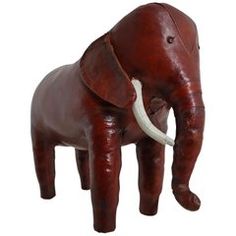 an elephant statue made out of leather with tusks on it's back