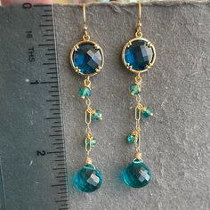 Turquoise Faceted Drop Earrings, Blue Briolette Jewelry For Party, Gold Long Drop Jewelry With Gemstone Accents, Blue Faceted Long Drop Jewelry, Blue Faceted Dangle Earrings, Blue 14k Gold-filled Dangle Jewelry, Blue Faceted Drop Jewelry, Nickel Free Blue Briolette Jewelry, Gold Faceted Dangle Crystal Earrings