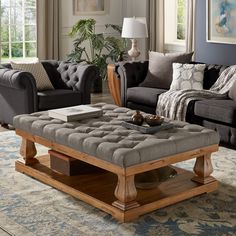 a living room with two couches, a coffee table and a rug on the floor