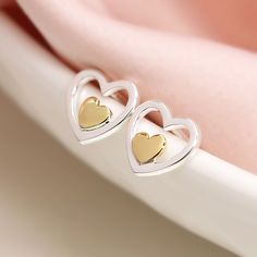 A stunning pair of sweet double heart stud earrings made from sterling silver with a golden touch on the inner heart These silver heart stud earrings feature a classic butterfly and post fastening and are suitable for almost any age. A lovely Christmas gift, stocking filler or for a birthday treat for someone you love. Versatile and easy-to-wear, our stunning earrings shine when worn on their own or will add some sparkle to your stacked earring look in a second or third piercing. A wonderfully t Gold Double Heart Sterling Silver Earrings, Personalized Pink Double Heart Jewelry, Gold Double Heart Nickel-free Earrings, Pink Double Heart Sterling Silver Earrings, Pink Heart-shaped Adjustable Earrings, Double Heart, 50th Birthday Gifts, Heart Studs, Heart Earrings Studs