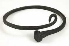 an old black metal hook on a white background